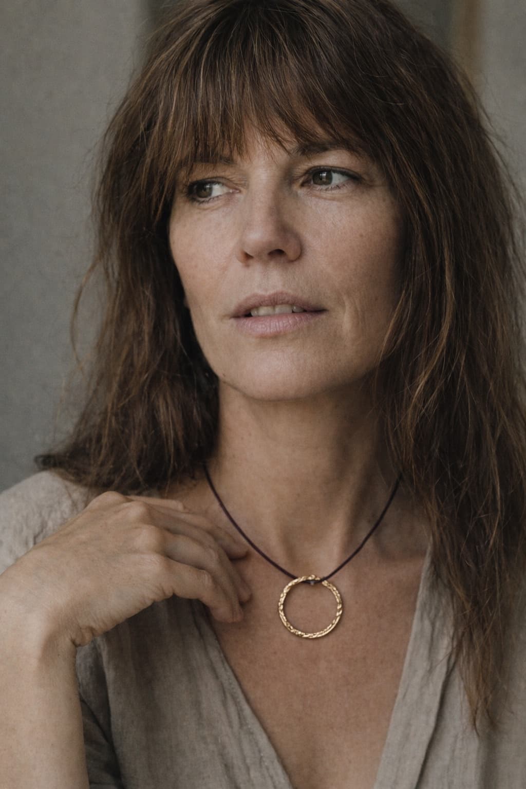 Generated model wearing the hammered gold pendant